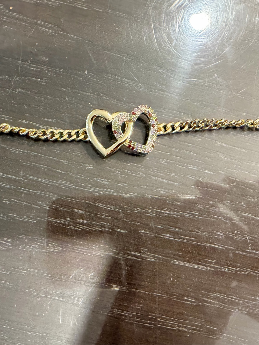 Gold-Tone Interlocking Heart Bracelet with Crystal Accents